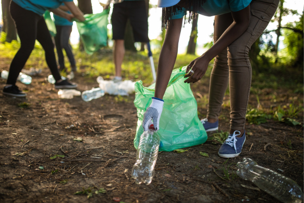 Group of volunteers picking up litter to show the qualities needed to be an effective environmental enforcement officer