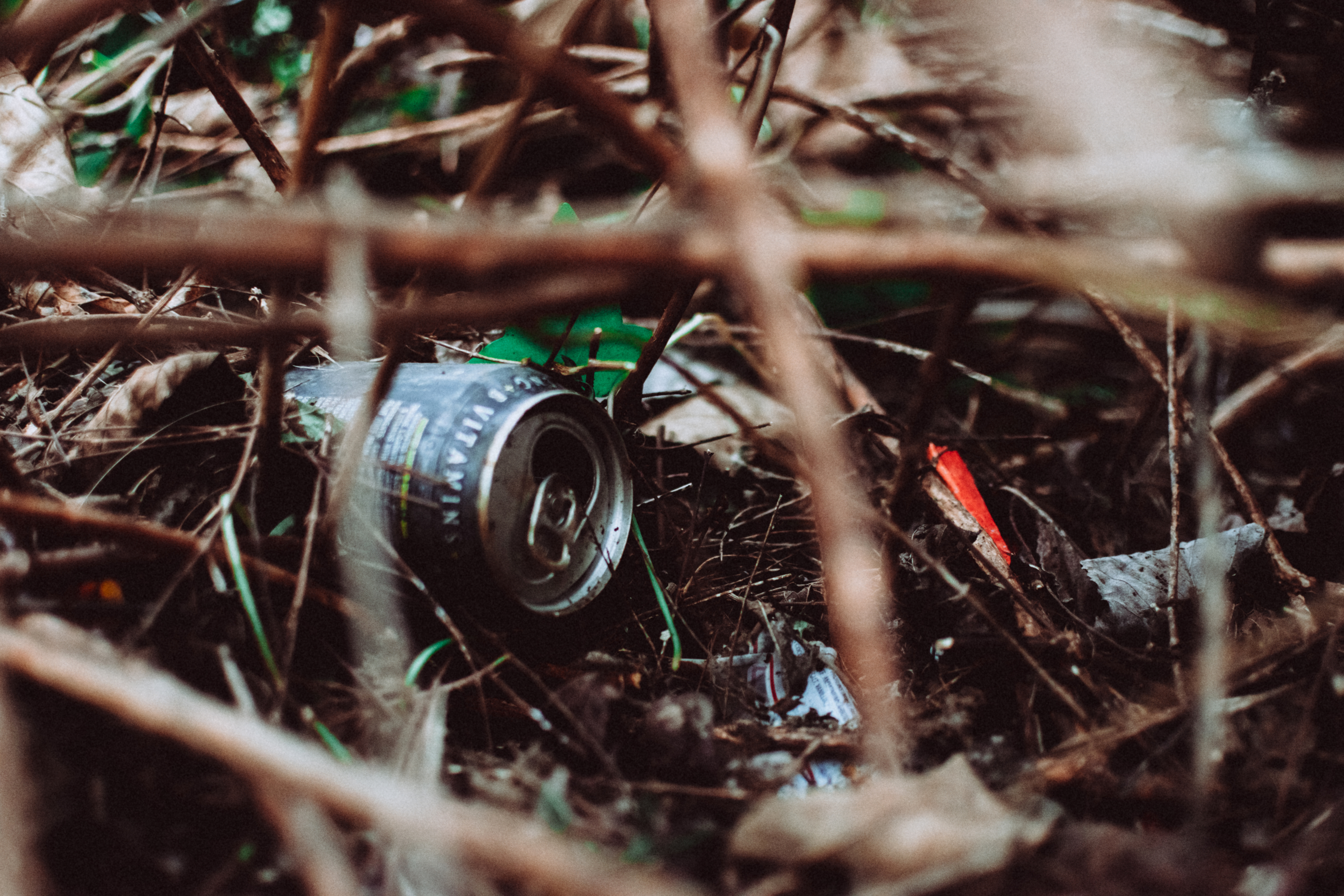 gray can buried amongst sticks in the ground to show facts you didn't know about environmental enforcement officers