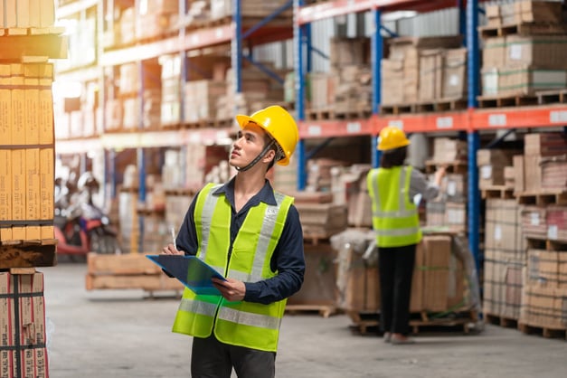 A man is starting his new job as a warehouse operative. 