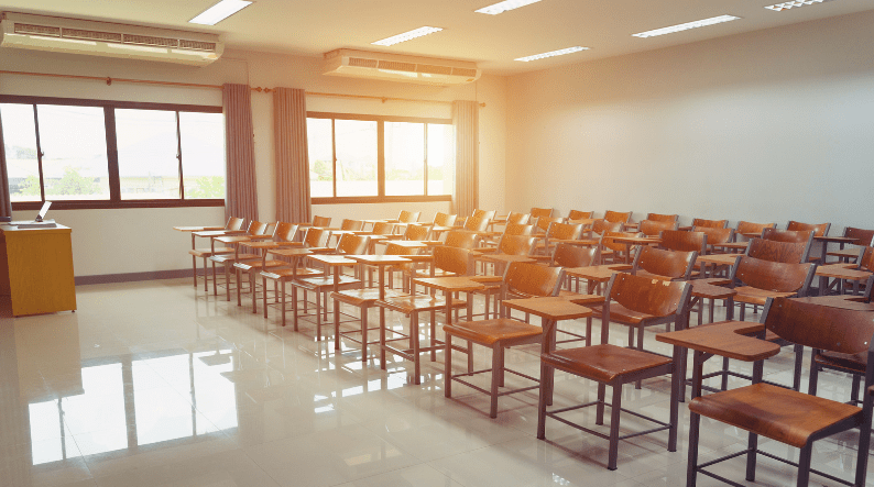 An empty university classroom showing why they should hire an outsourced cleaning service