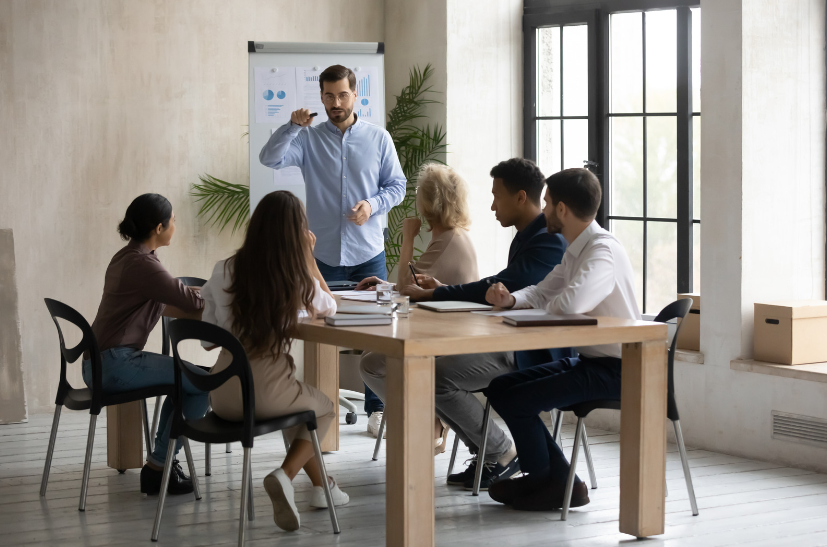 A manager training employees in an office to show benefits of training employees in your workplace