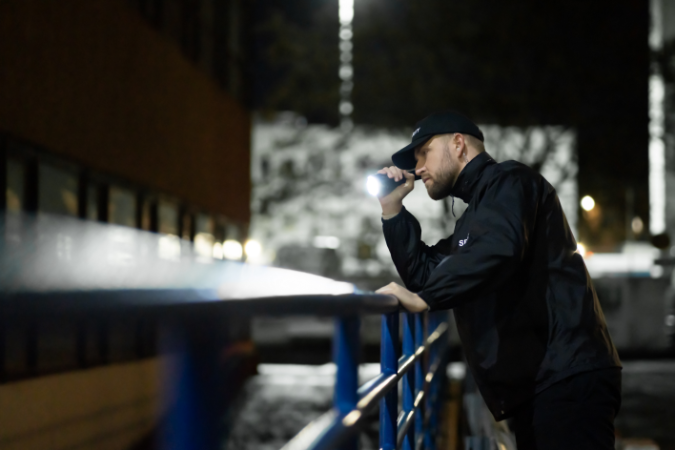 A security officer and key holder patrolling the perimeter of a building and working to protect your staff from risk.
