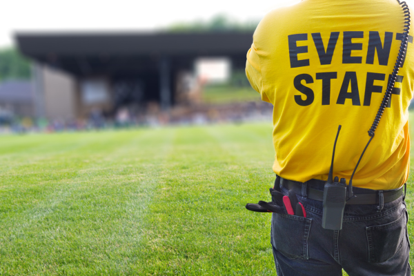 A security officer stewarding an outdoor concert event, acting according to Martyn’s Law.