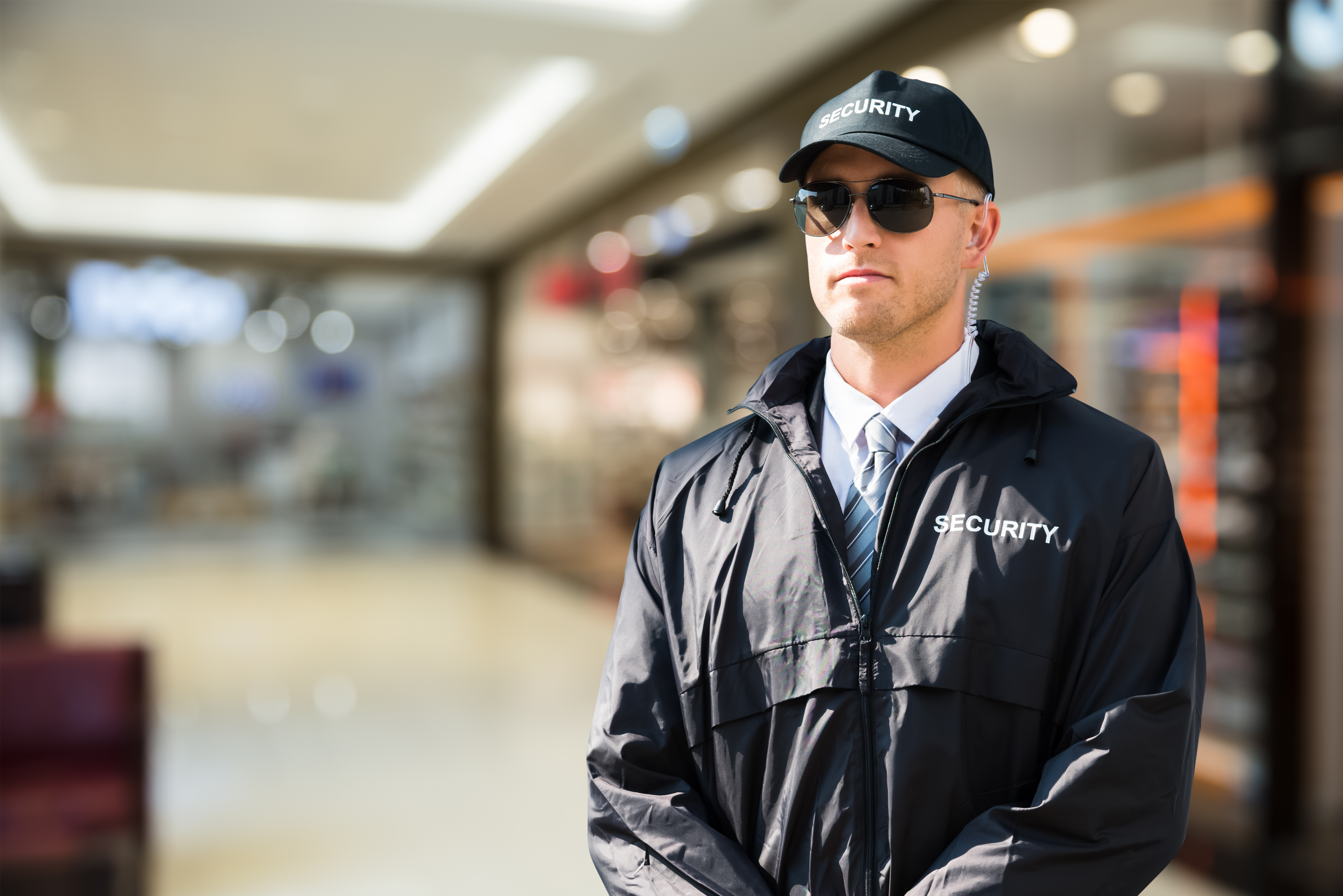 A security guard holds onto his radio to show the positive behaviours to look out for in the role.