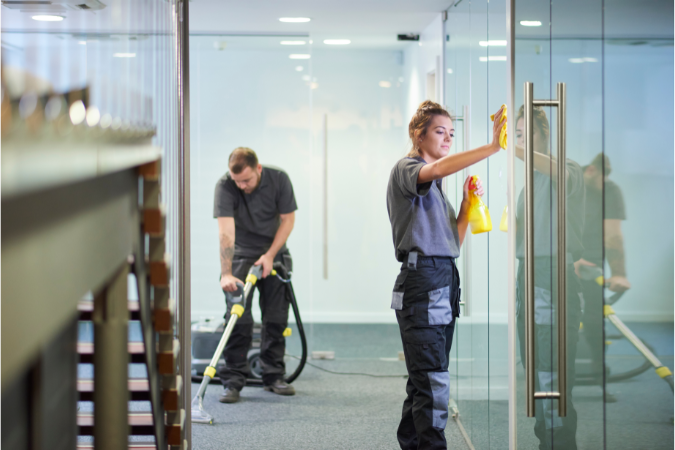 A team of skilled cleaners effectively cleaning a local authority building which highlights the advantages of outsourcing your cleaning services.